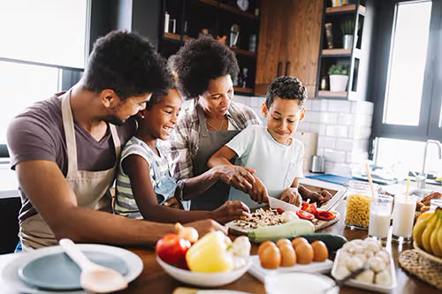 Family in a kitchen preparing food